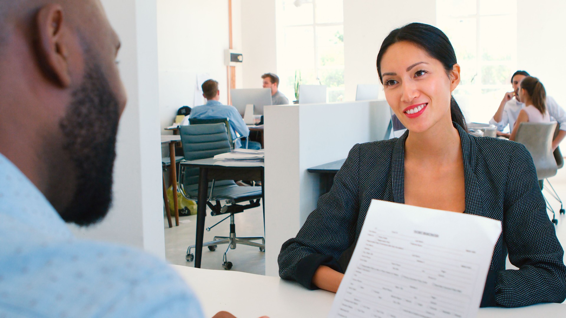 Woman Attending Job Interview In Modern Open Plan Office